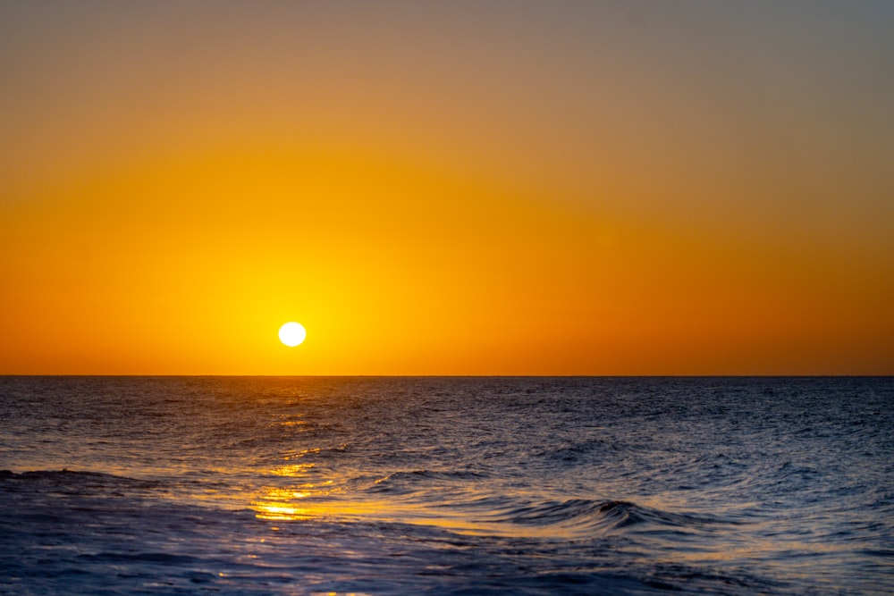 body of water during sunset