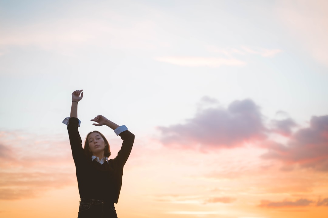 woman in black long sleeve shirt practicing tai chi to lower stress