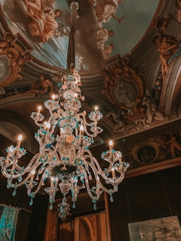clear glass chandelier turned on in room
