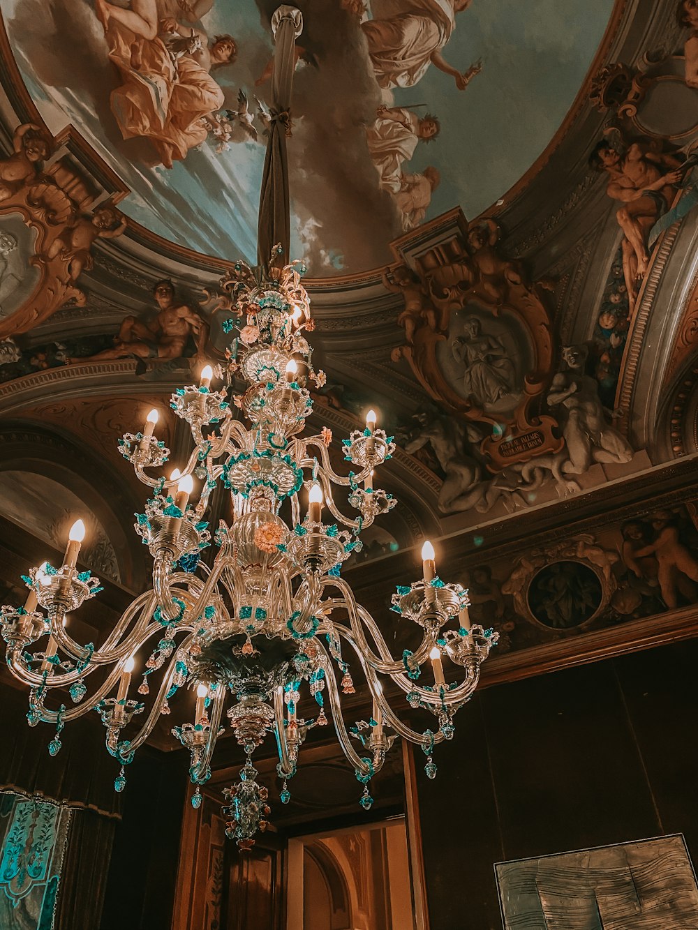 clear glass chandelier turned on in room