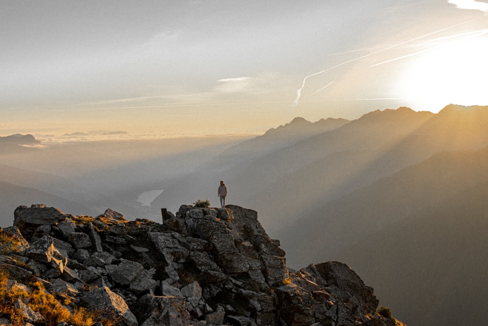 person standing on rock formation during daytime