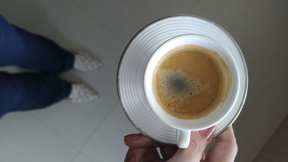 white ceramic mug with brown liquid