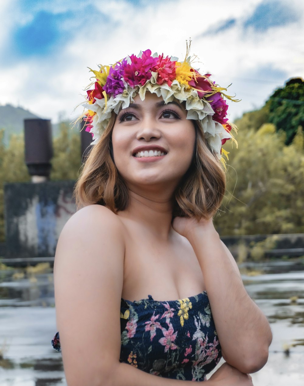 woman in black and white floral tube top smiling