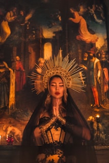 woman in brown dress with gold crown