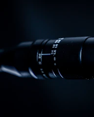 Close-up of a professional camera lens focusing on a product for marketing visuals.