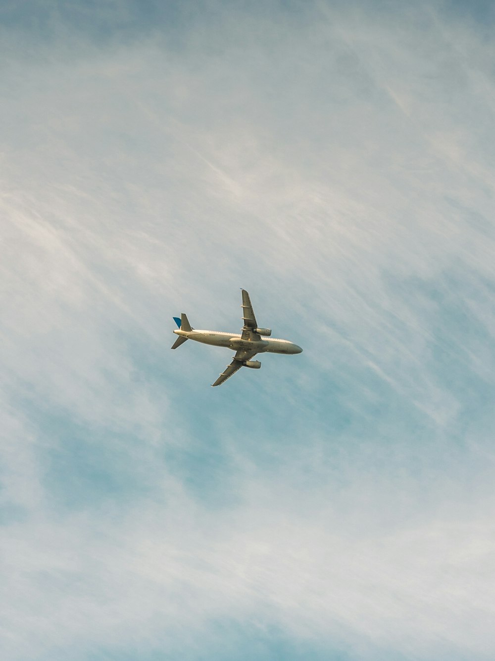 white airplane flying in the sky during daytime