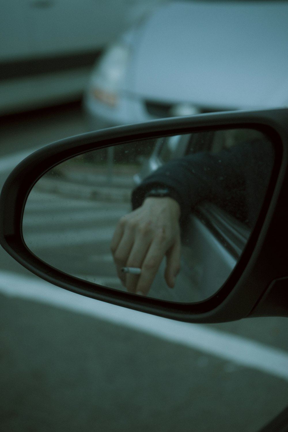 person holding car side mirror