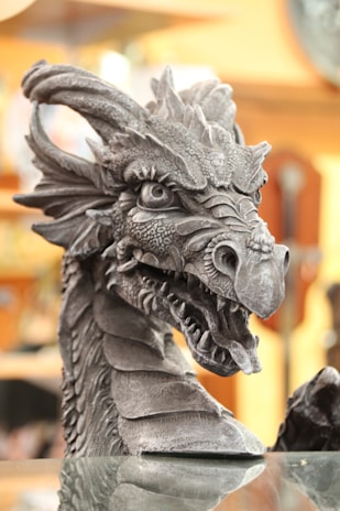 gray dragon statue in tilt shift lens