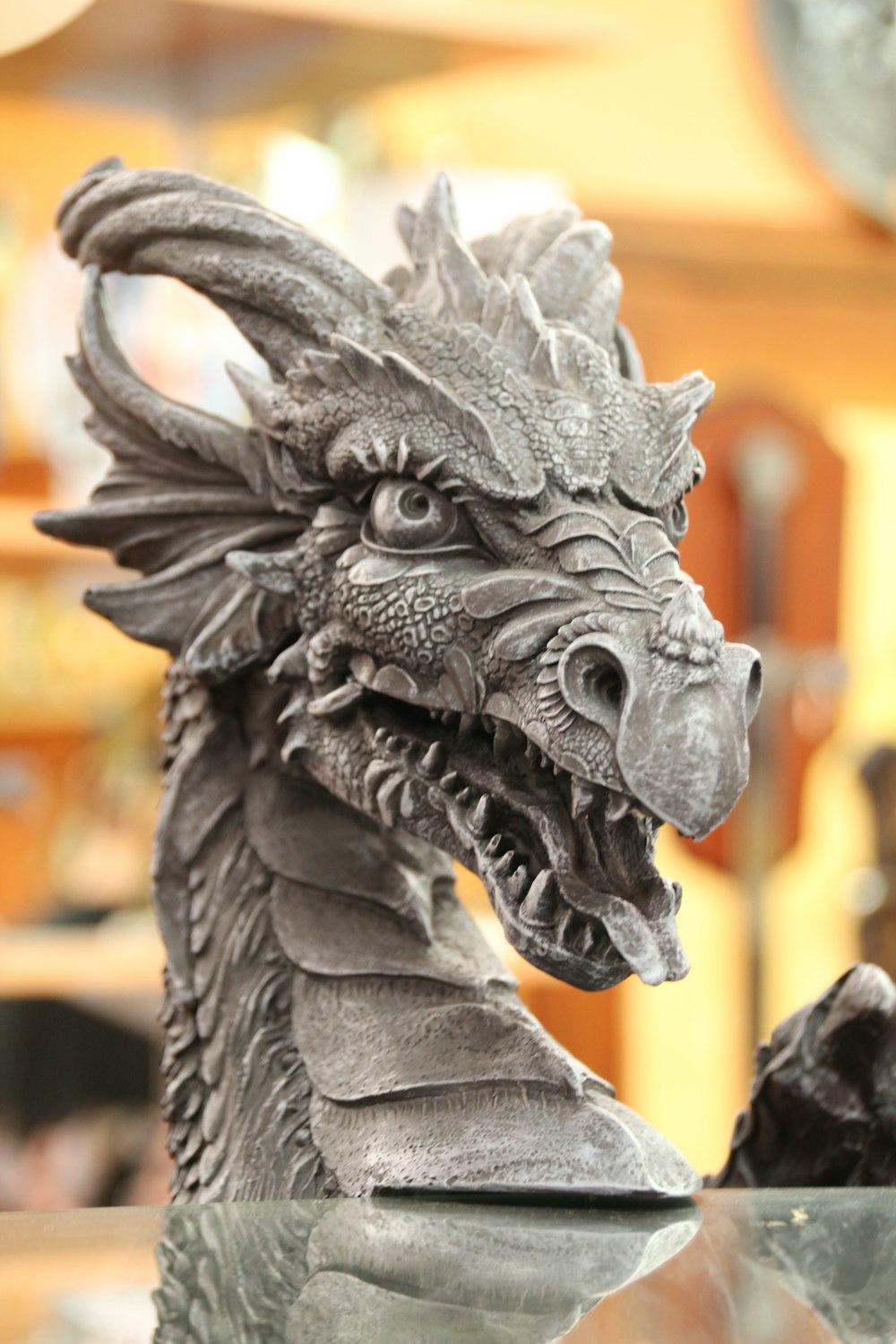 gray dragon statue in tilt shift lens