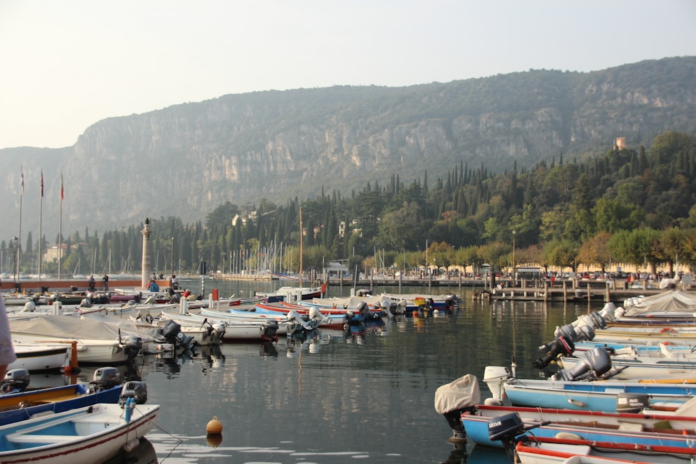 boats on river near mountain during daytime