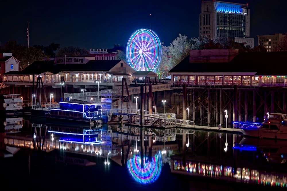 ferris wheel near body of water during night time