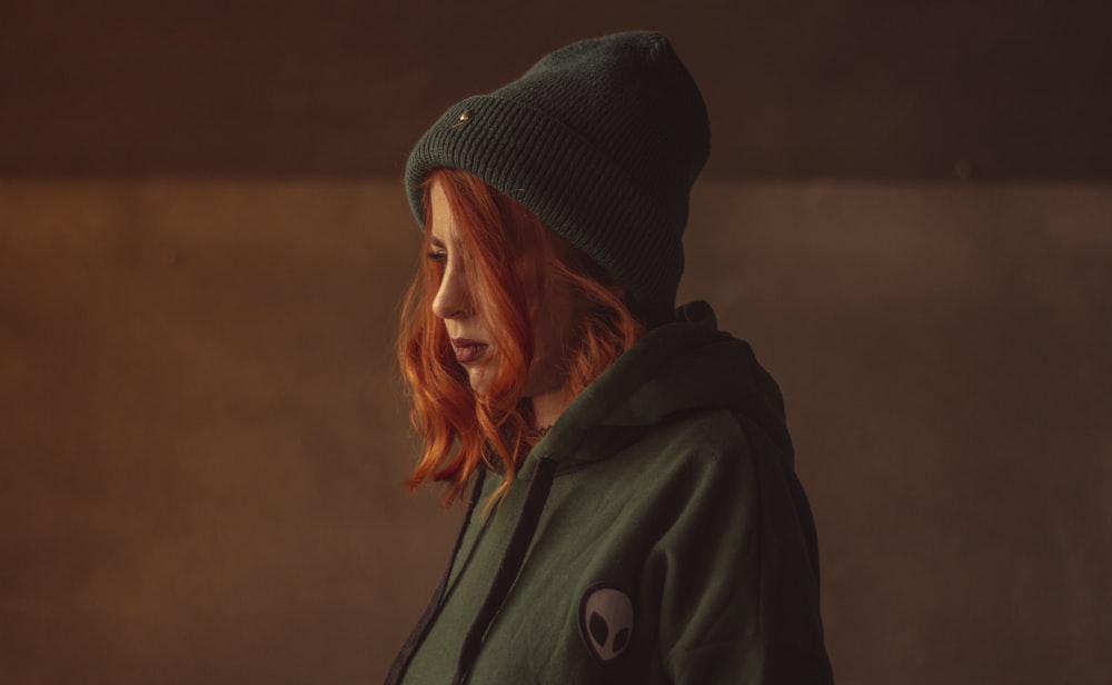 woman in black knit cap and gray coat