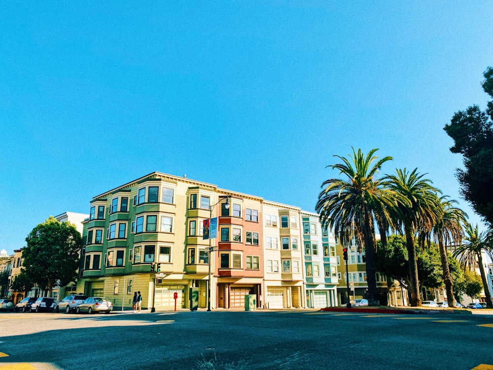 green palm tree near beige concrete building during daytime