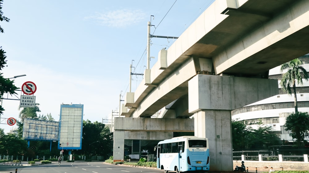 white and blue bus on road during daytime