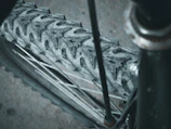 Close-up of a mountain bike tire gripping a rocky, uneven dirt path.