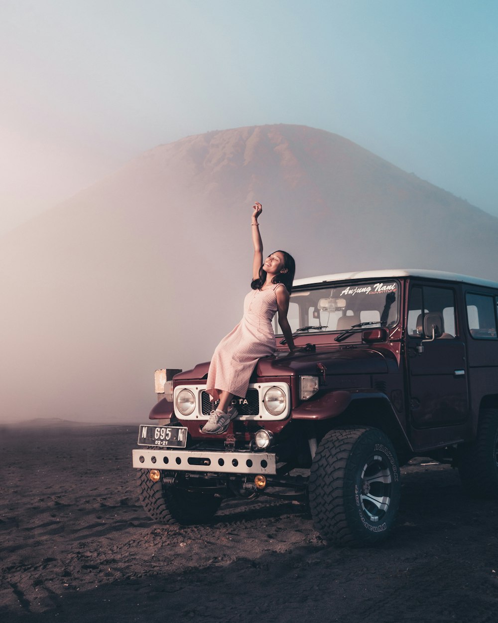 woman in white dress sitting on white jeep wrangler