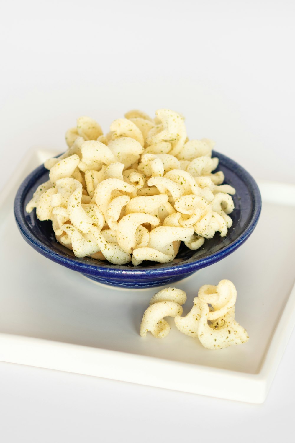 white and brown food on blue ceramic bowl