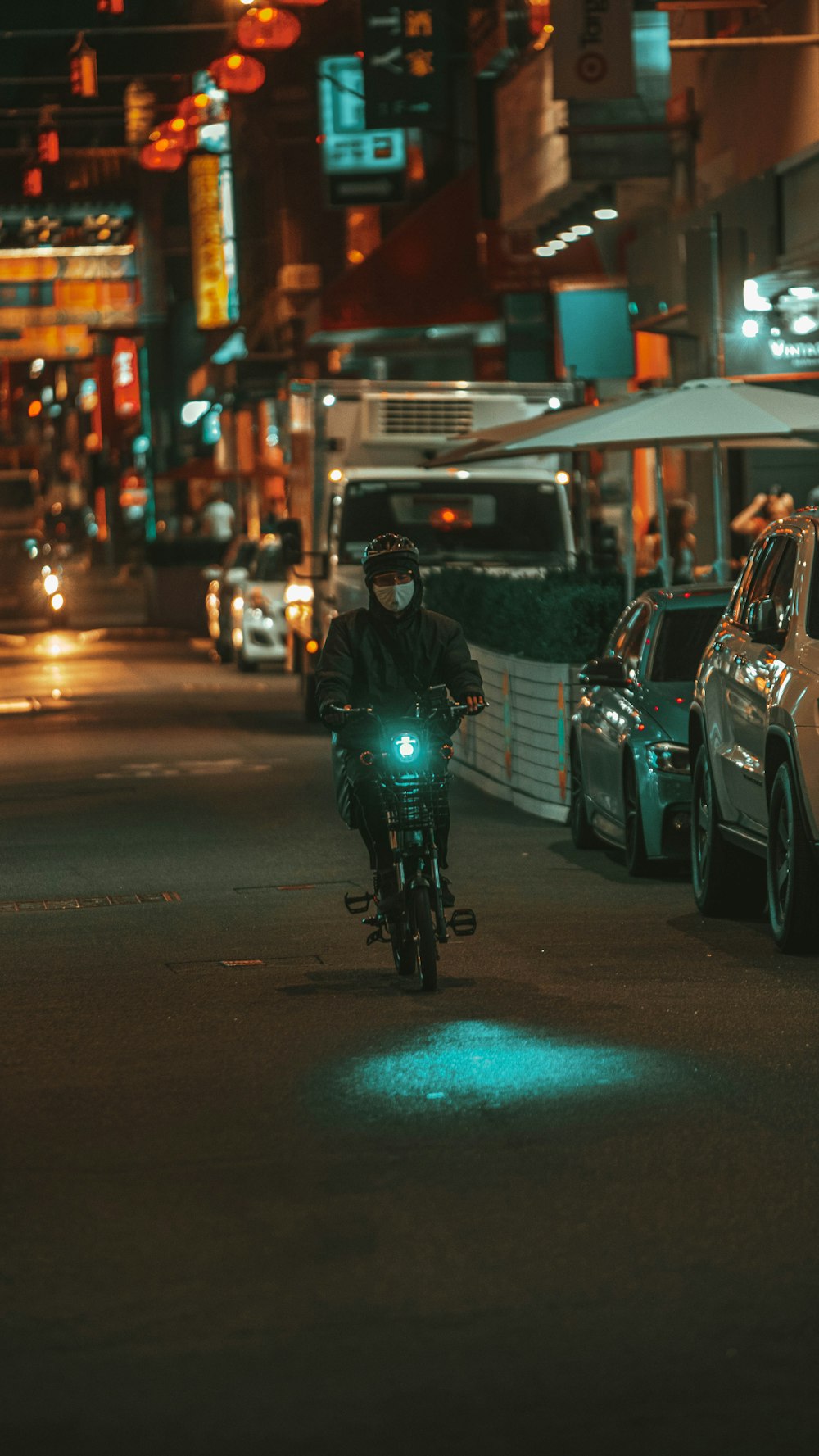 man in black jacket riding on motorcycle during night time