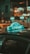 A taxi roof sign with the word 'CHAMP' is prominently displayed against a blurred urban nighttime background. The sign is illuminated and casts a reflection on the car roof, surrounded by bokeh lights in the background, creating a vibrant and dynamic scene.