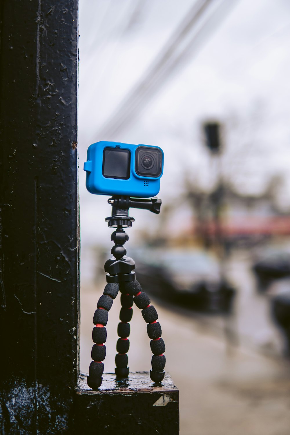blue and black camera on black metal stand