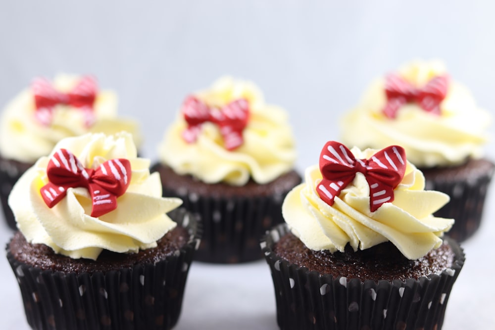 cupcakes with white icing and red and yellow sprinkles