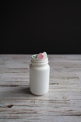 A close-up of soothing throat lozenges and syrup bottles arranged on a wooden table.