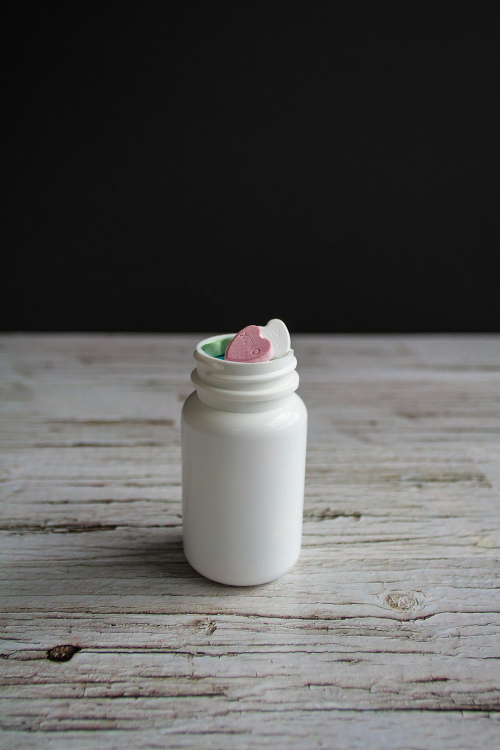 white plastic bottle on brown wooden table