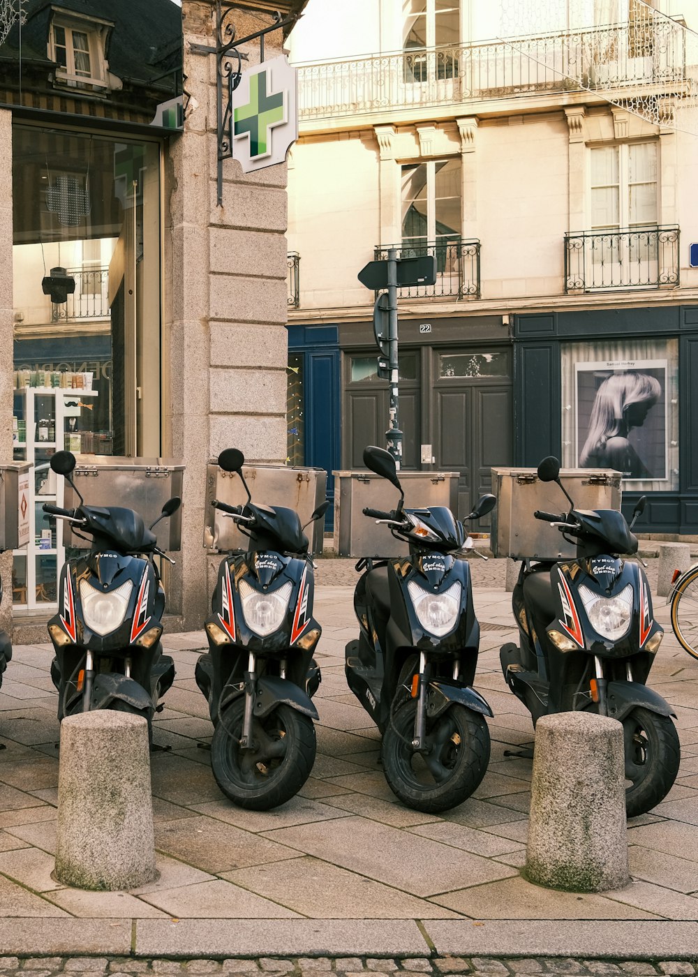 black and blue motor scooter parked beside brown concrete building during daytime