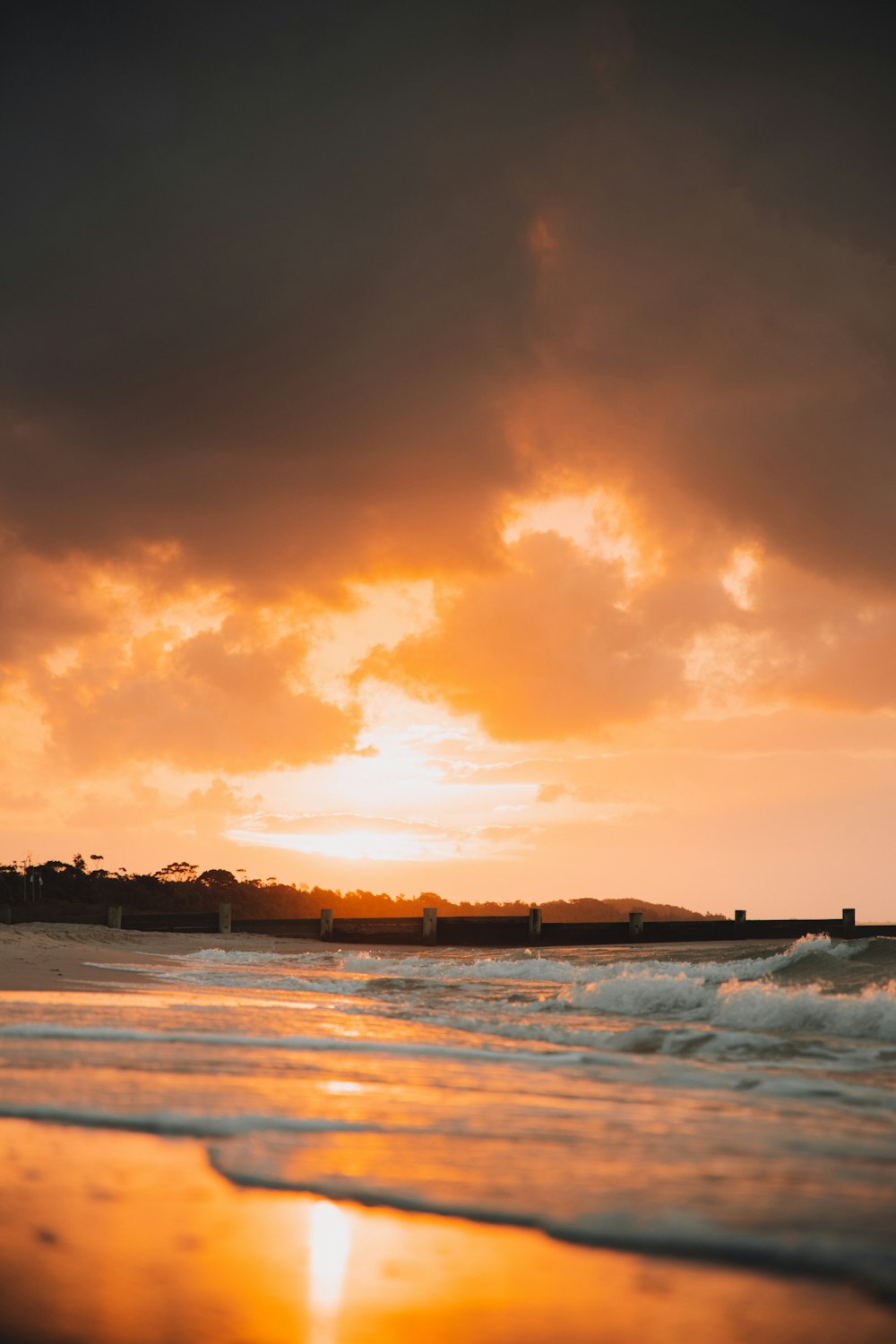 body of water under cloudy sky during sunset