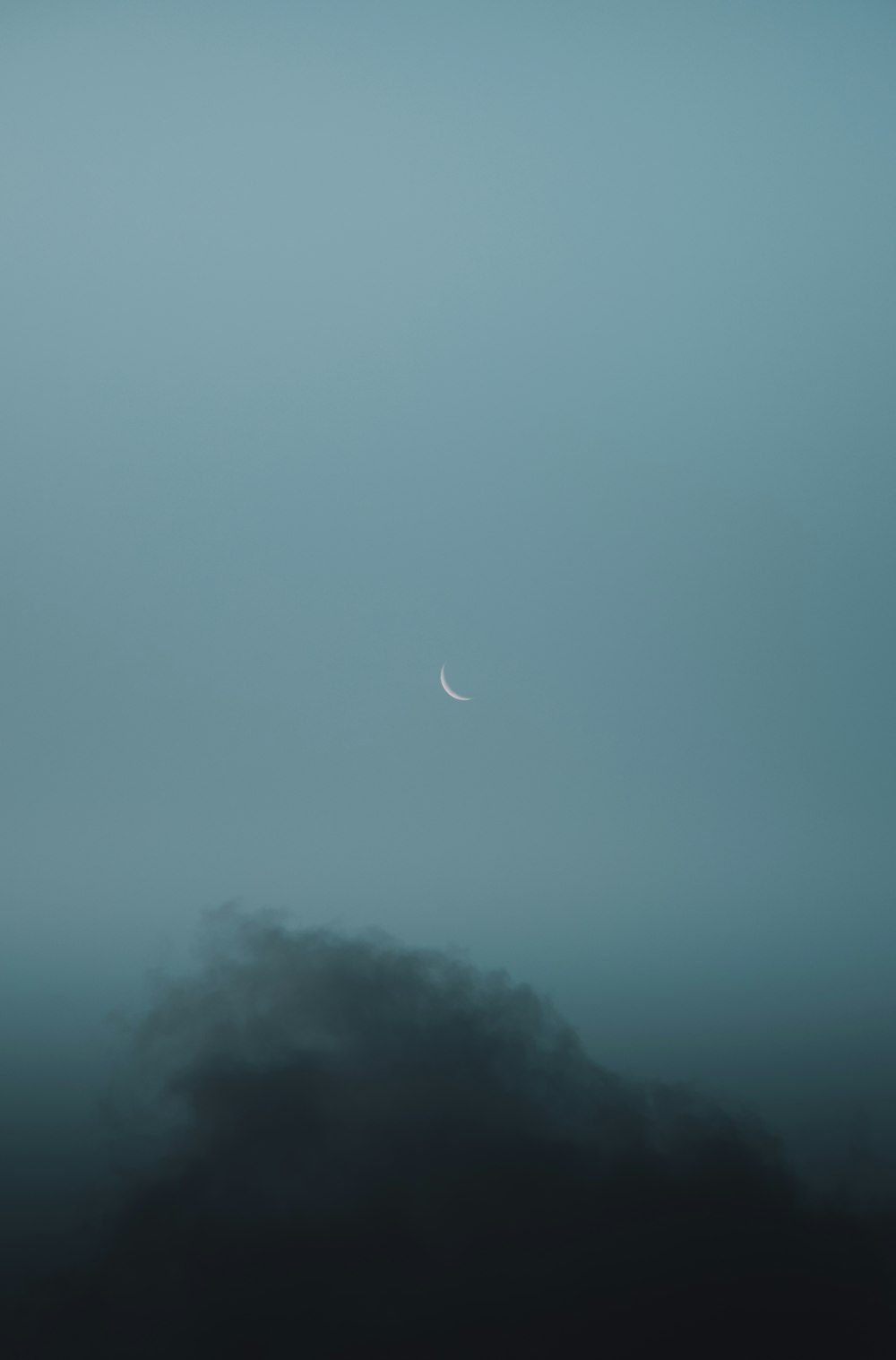 moon over clouds during night time