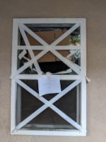 Close-up of a secure boarded window with professional signage from TrueNest Property Management LLC.