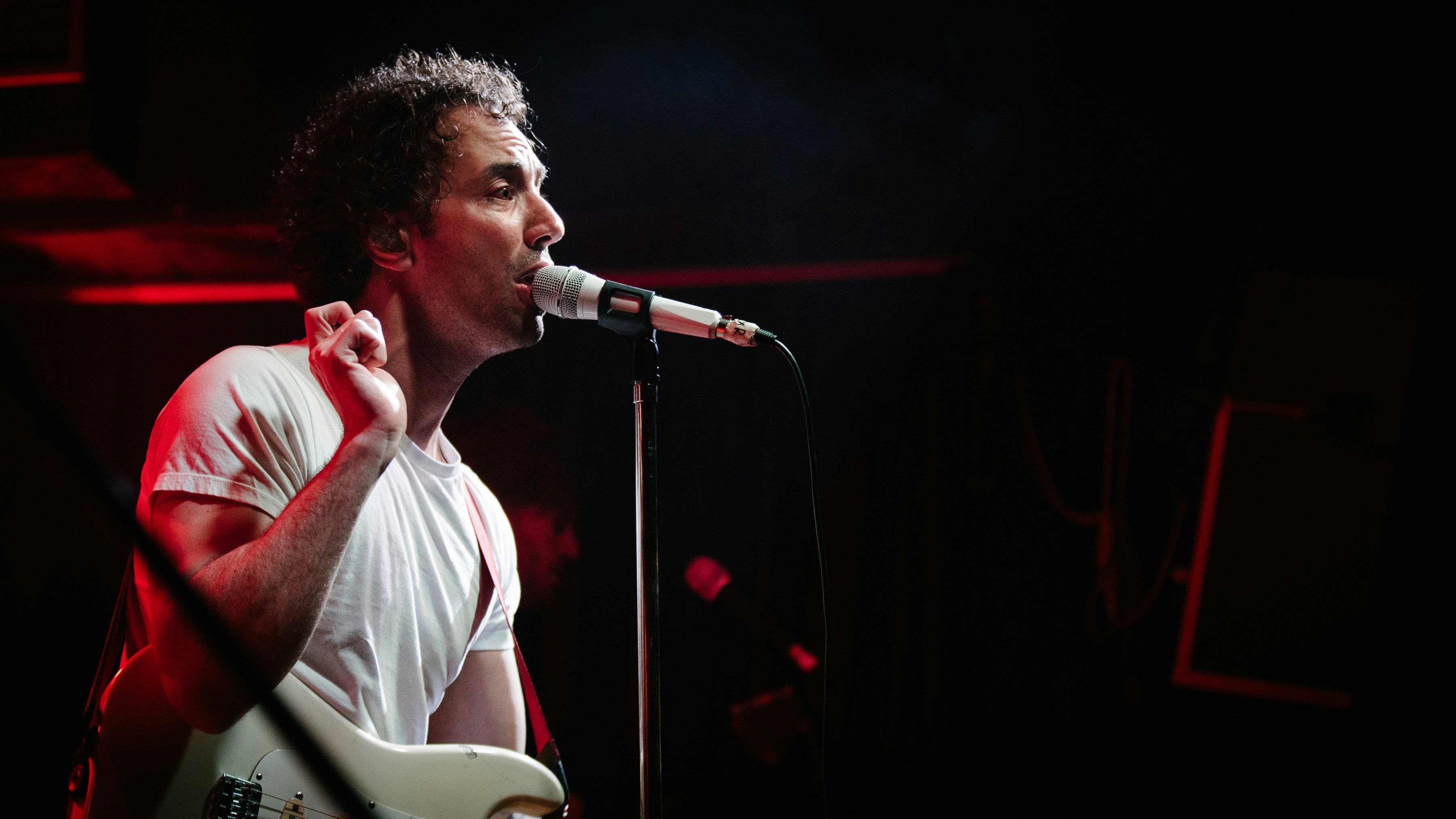 man in white shirt singing