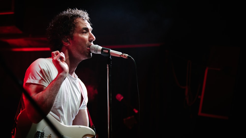 man in white shirt singing