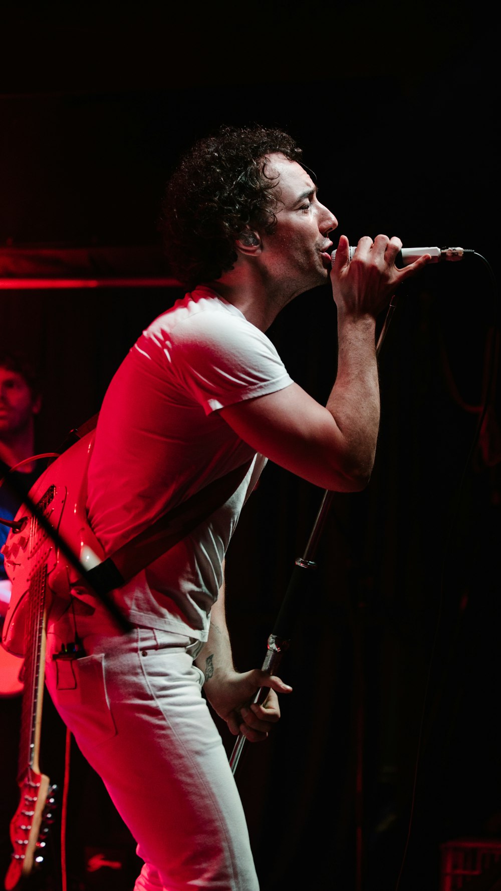 man in white t-shirt singing