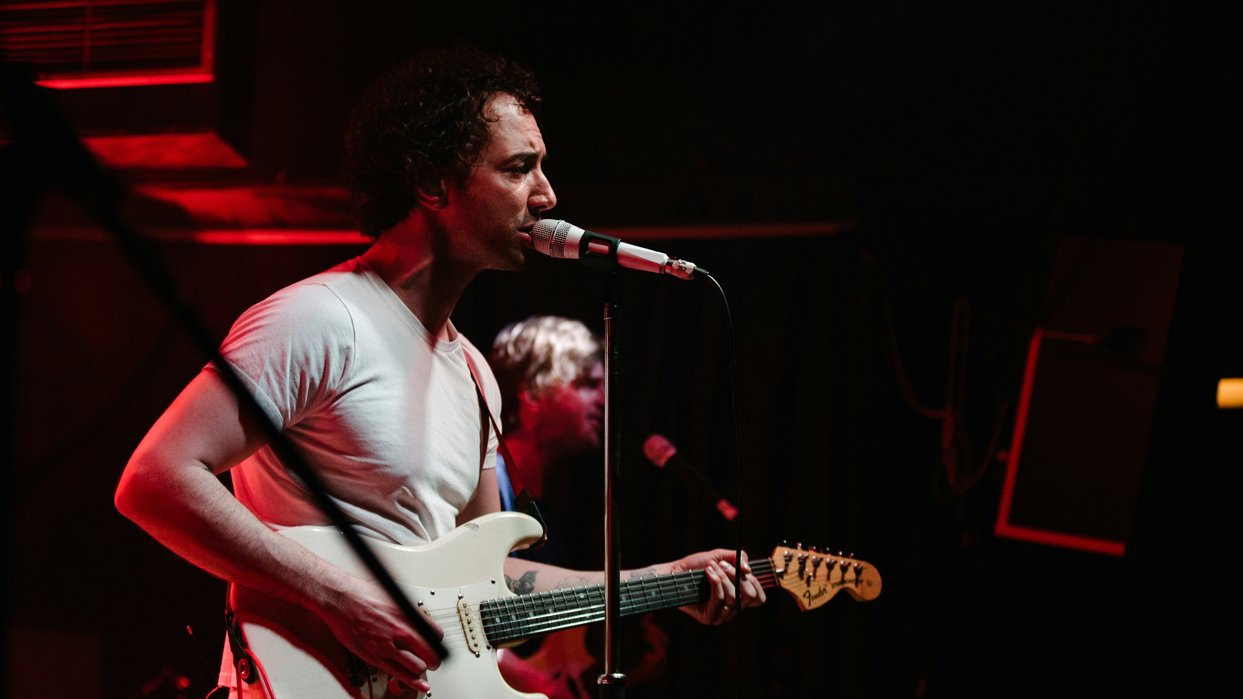 man in white shirt singing