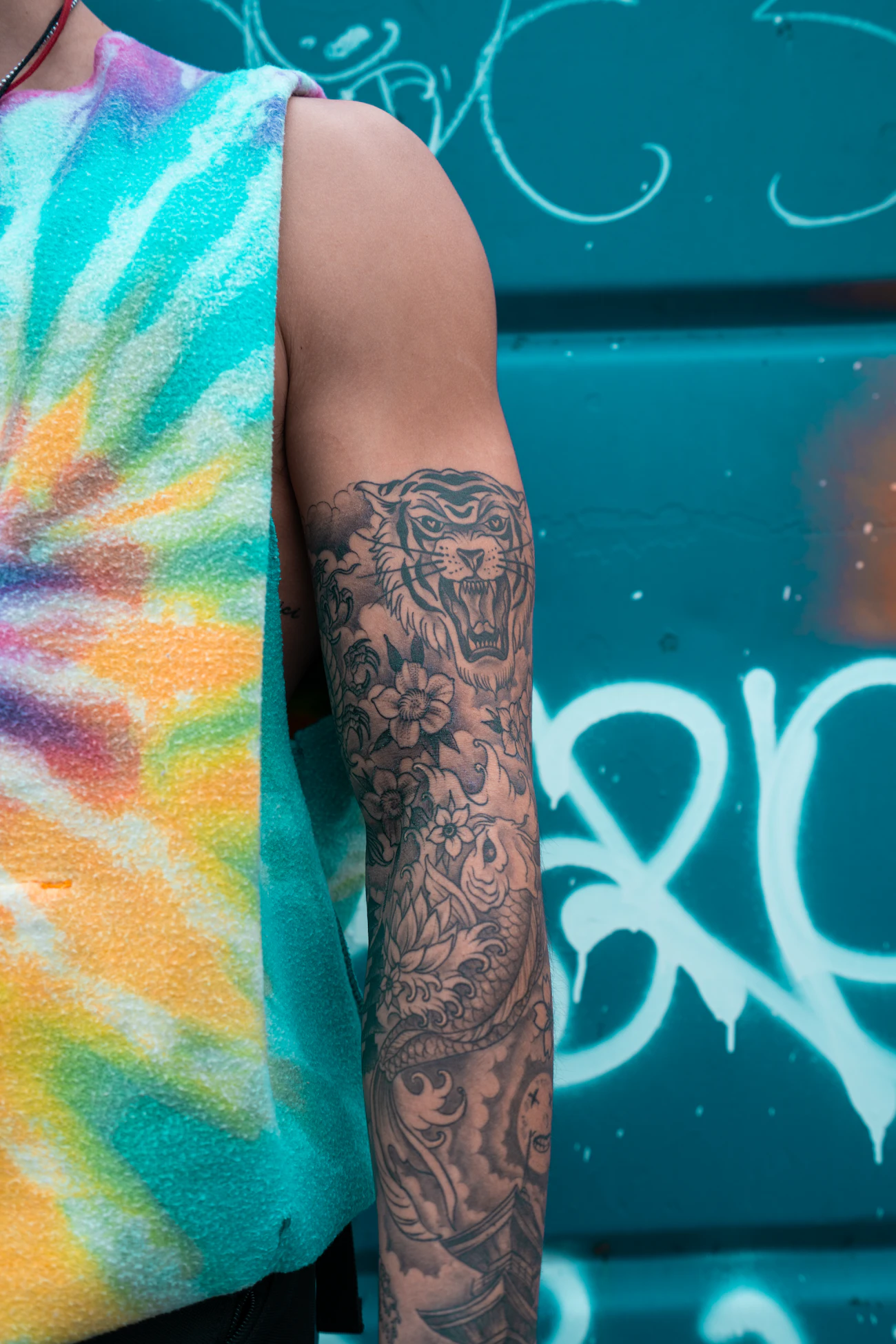 Close-up of a black-and-white floral tattoo on a person's arm, representing the tattoo-related concerns addressed alongside laser hair removal in this category