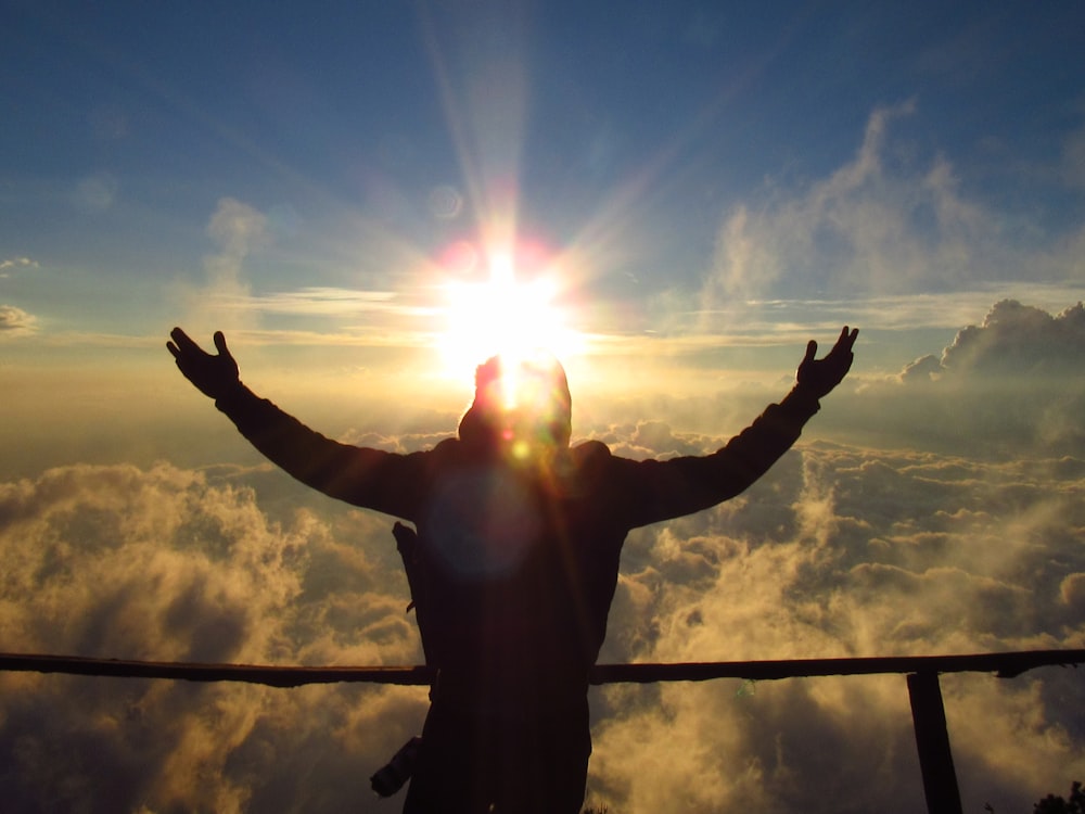 man in black pants standing under blue sky during daytime