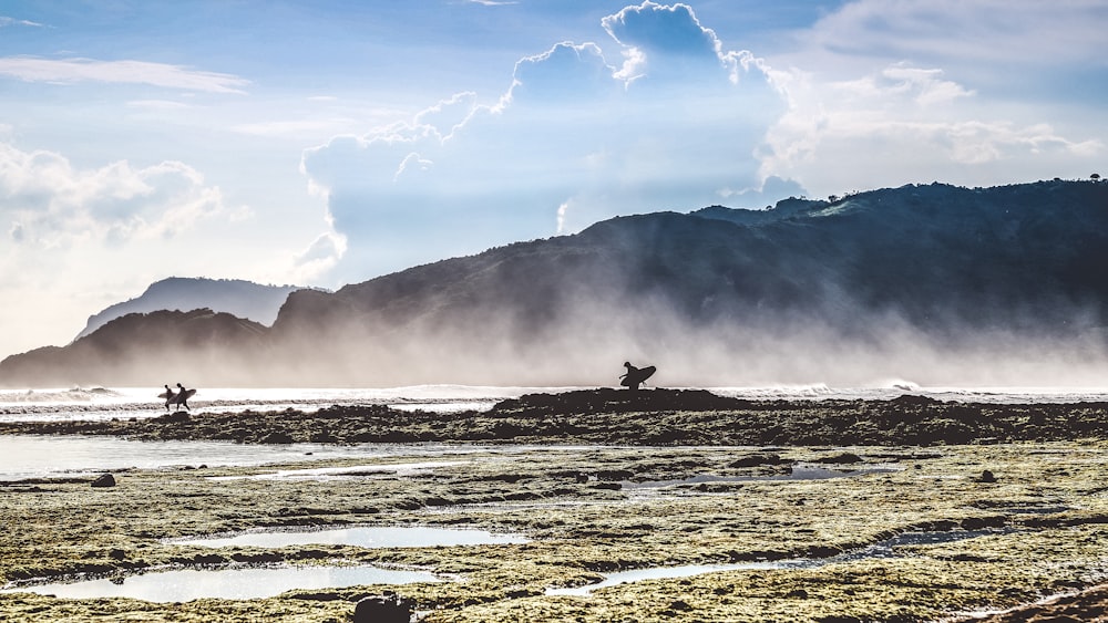 person standing on sea shore during daytime