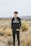 man in black and white adidas hoodie standing on brown grass field during daytime