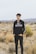 man in black and white adidas hoodie standing on brown grass field during daytime