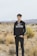 man in black and white adidas hoodie standing on brown grass field during daytime