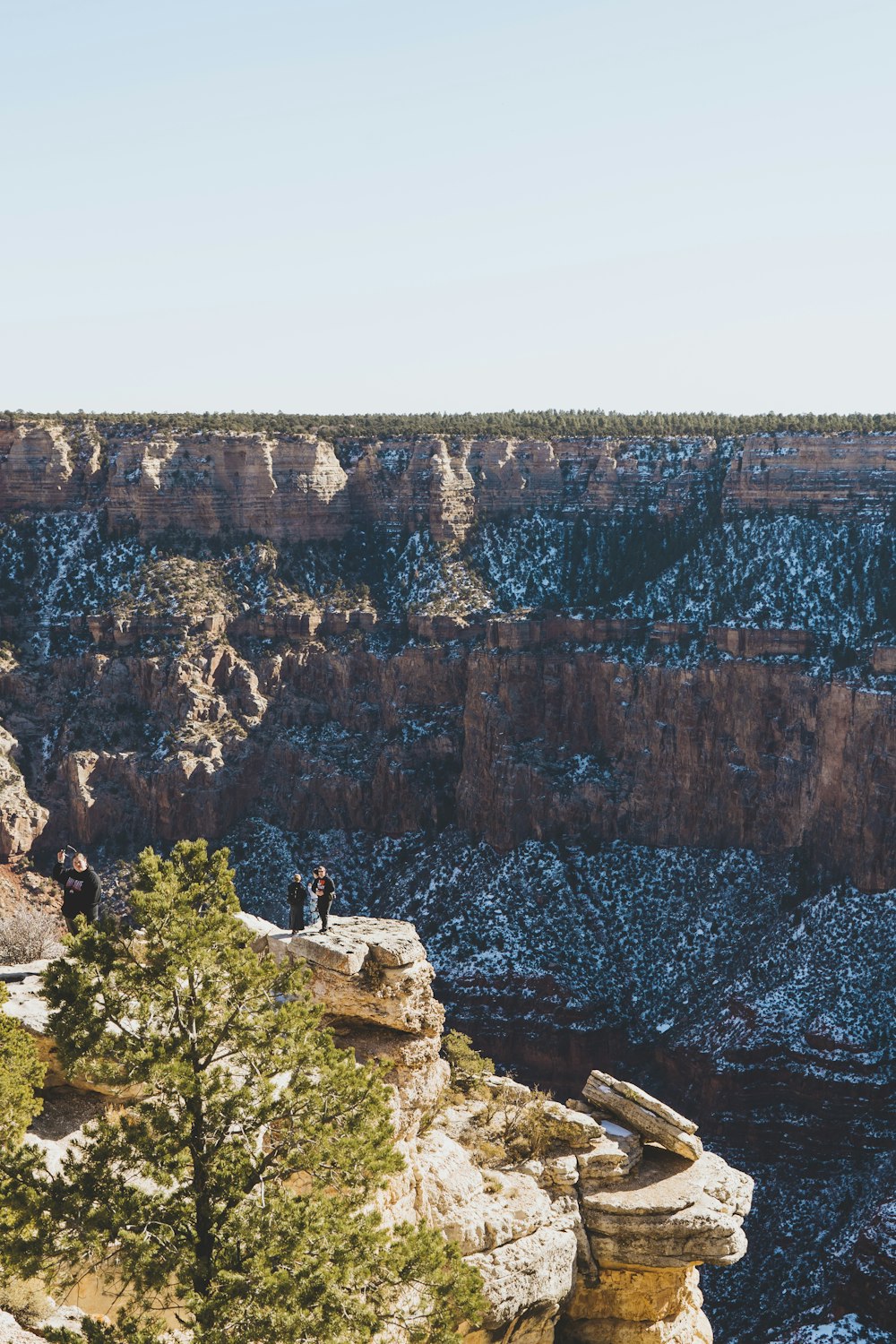 person sitting on rock formation during daytime