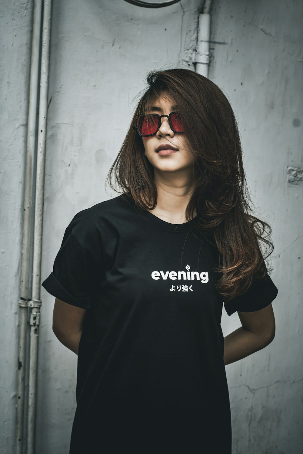 woman in black crew neck t-shirt wearing red sunglasses