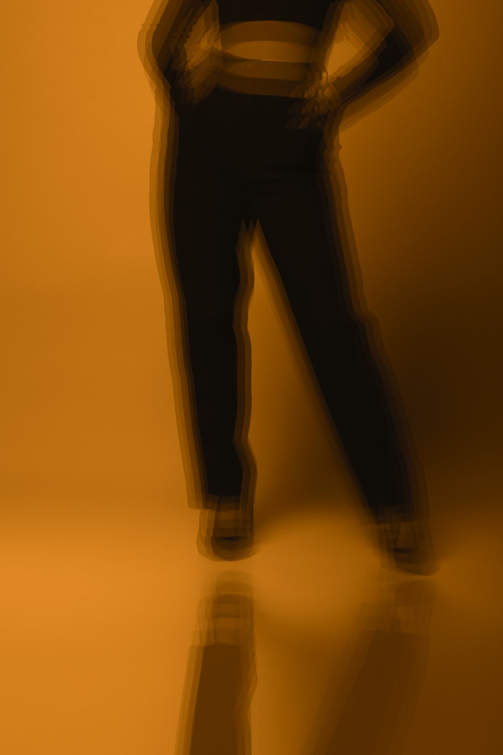 silhouette of person wearing black pants and black shoes
