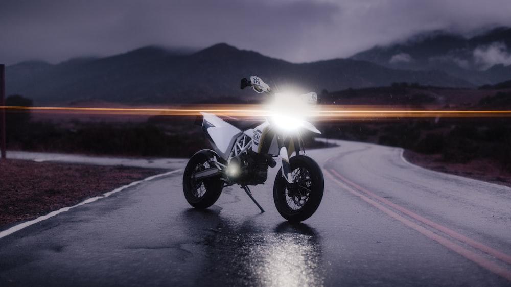 black motorcycle on road during sunset