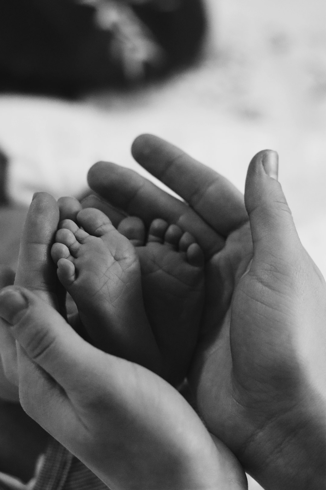 grayscale photo of babys feet