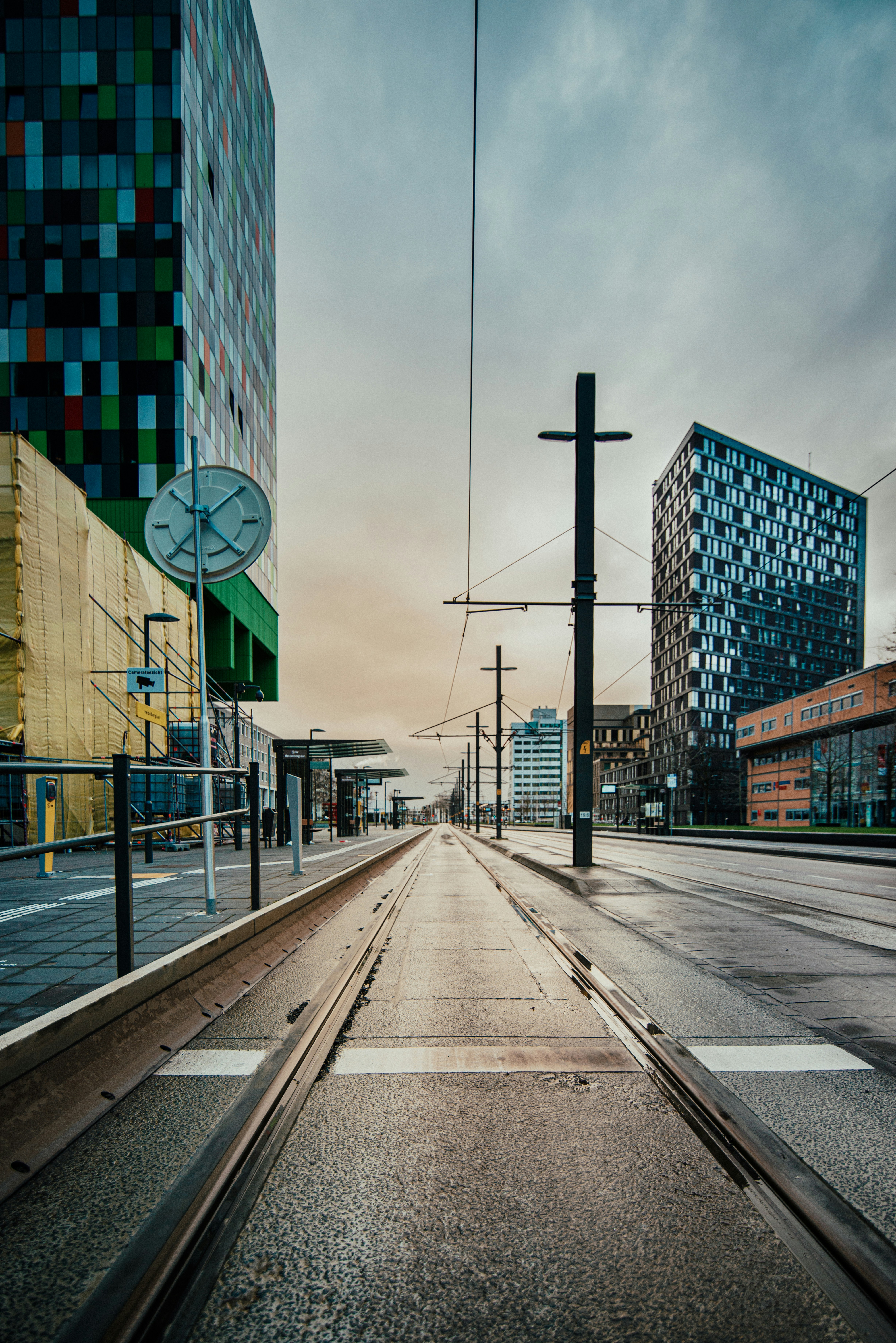 gray concrete road between buildings during daytime