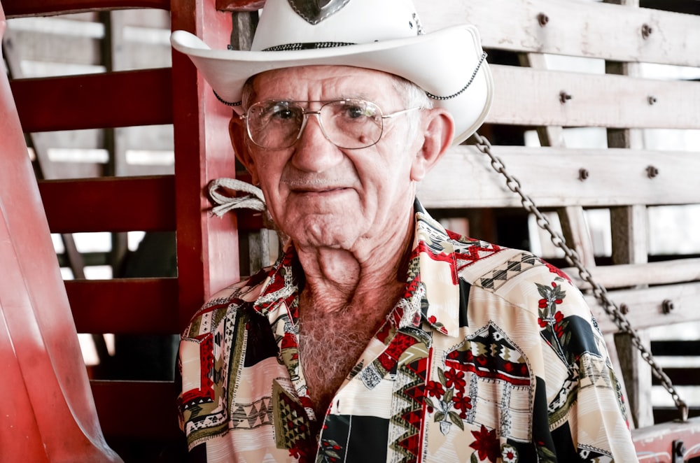 man in white cowboy hat and red and white floral button up shirt