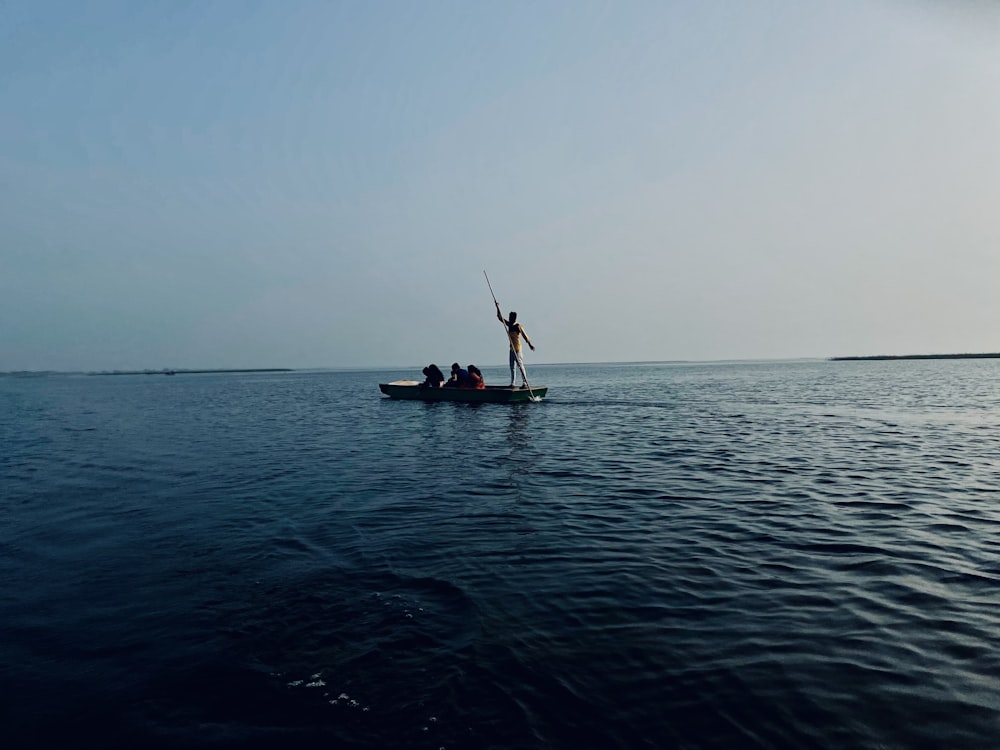 2 person riding on boat on sea during daytime