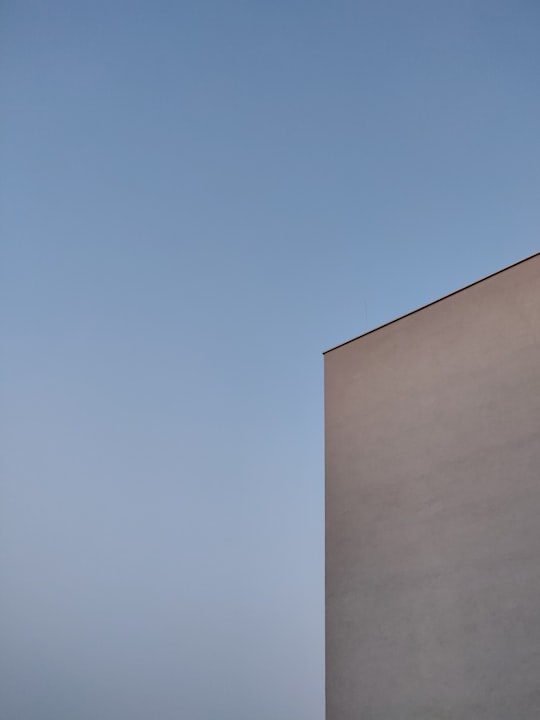 white concrete building under blue sky during daytime in Graz Austria